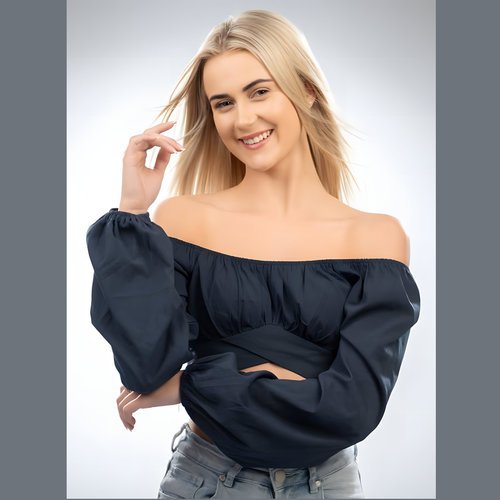 Front view of women's black cotton off-shoulder top with elastic neckline and puff sleeve